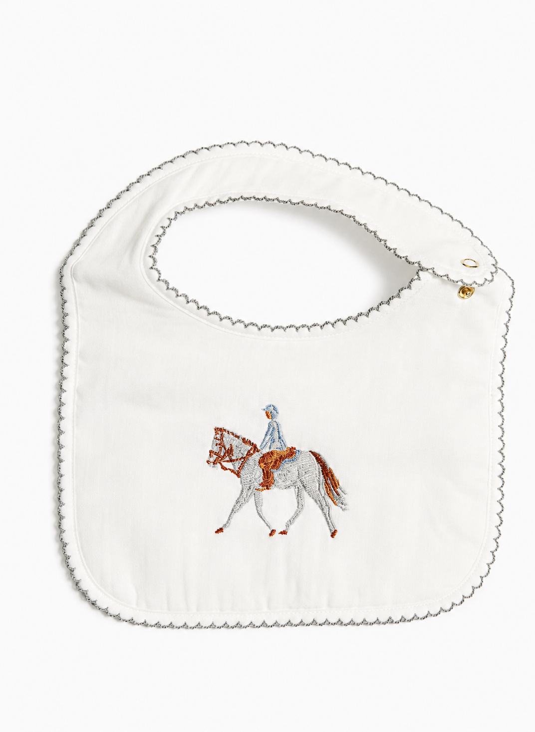 An off-white fabric baby bib with a scalloped edge and a central embroidered design of a horse and rider, shown on a plain white background.