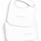 Two white baby bibs with light blue scalloped edges and the word 'amore' embroidered in light blue script, shown on a white background.