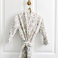 Floral patterned robe hanging on a white door