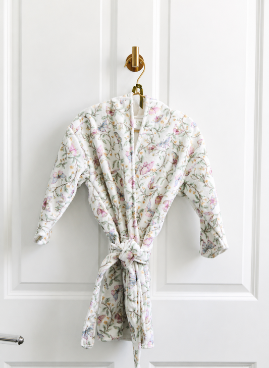 Floral patterned robe hanging on a white door