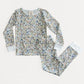 A children's long-sleeve pajama set with matching pants, featuring an all-over woodland animal print in muted blue, brown, and beige tones on a light background, with solid light blue cuffs.
