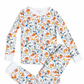 A two-piece children's pajama set featuring a long-sleeve top and matching pants, both printed with a colorful sports-themed pattern of soccer balls, tennis rackets, bats, and balls on a white background.