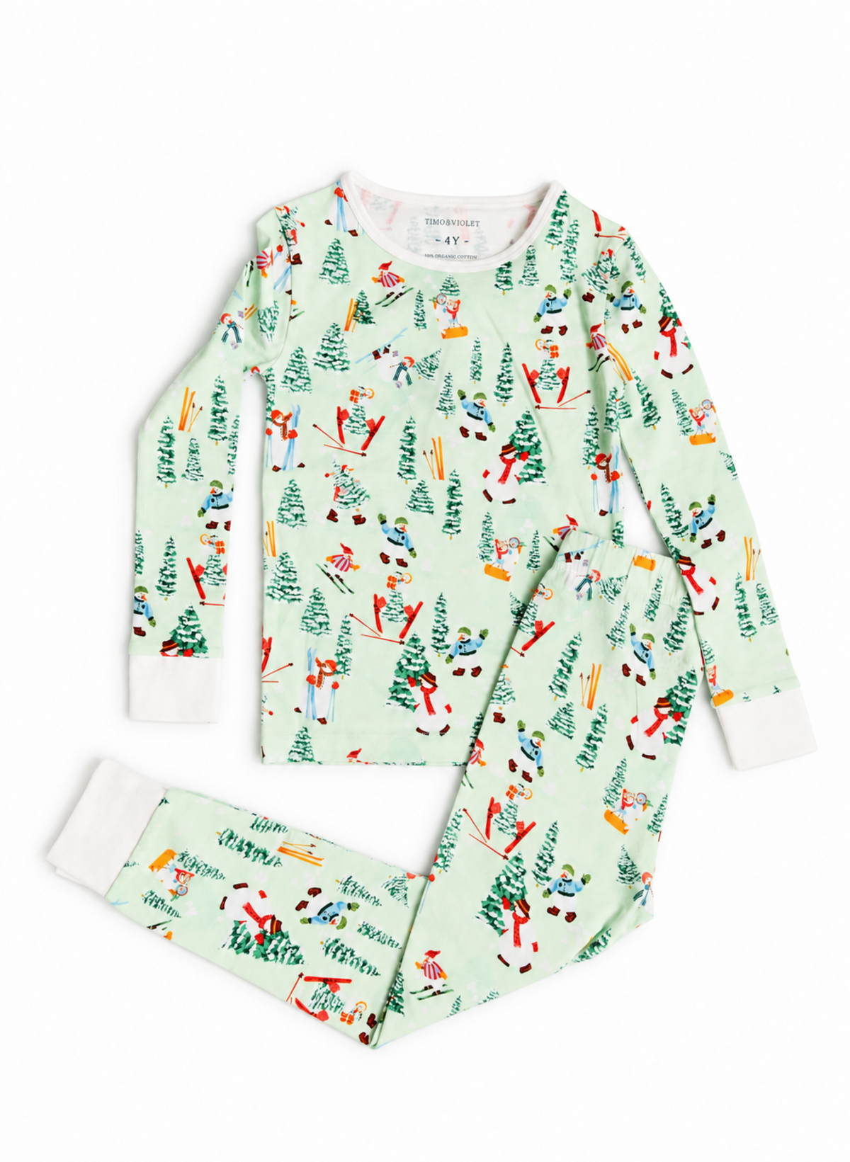 A two-piece children's pajama set from the brand Pajera, featuring a long-sleeve top and matching pants in a light mint green color with a colorful winter ski and Christmas tree pattern. The cuffs and collar are solid white.