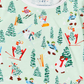 A close-up of a children's long-sleeve top by Timo & Violet, featuring a light mint green background with a colorful winter ski print. The pattern includes cartoon snowmen, skiers, and green pine trees.