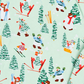 A close-up of a light mint green fabric printed with a winter ski and snowboard pattern featuring cartoon characters, pine trees, and skis.
