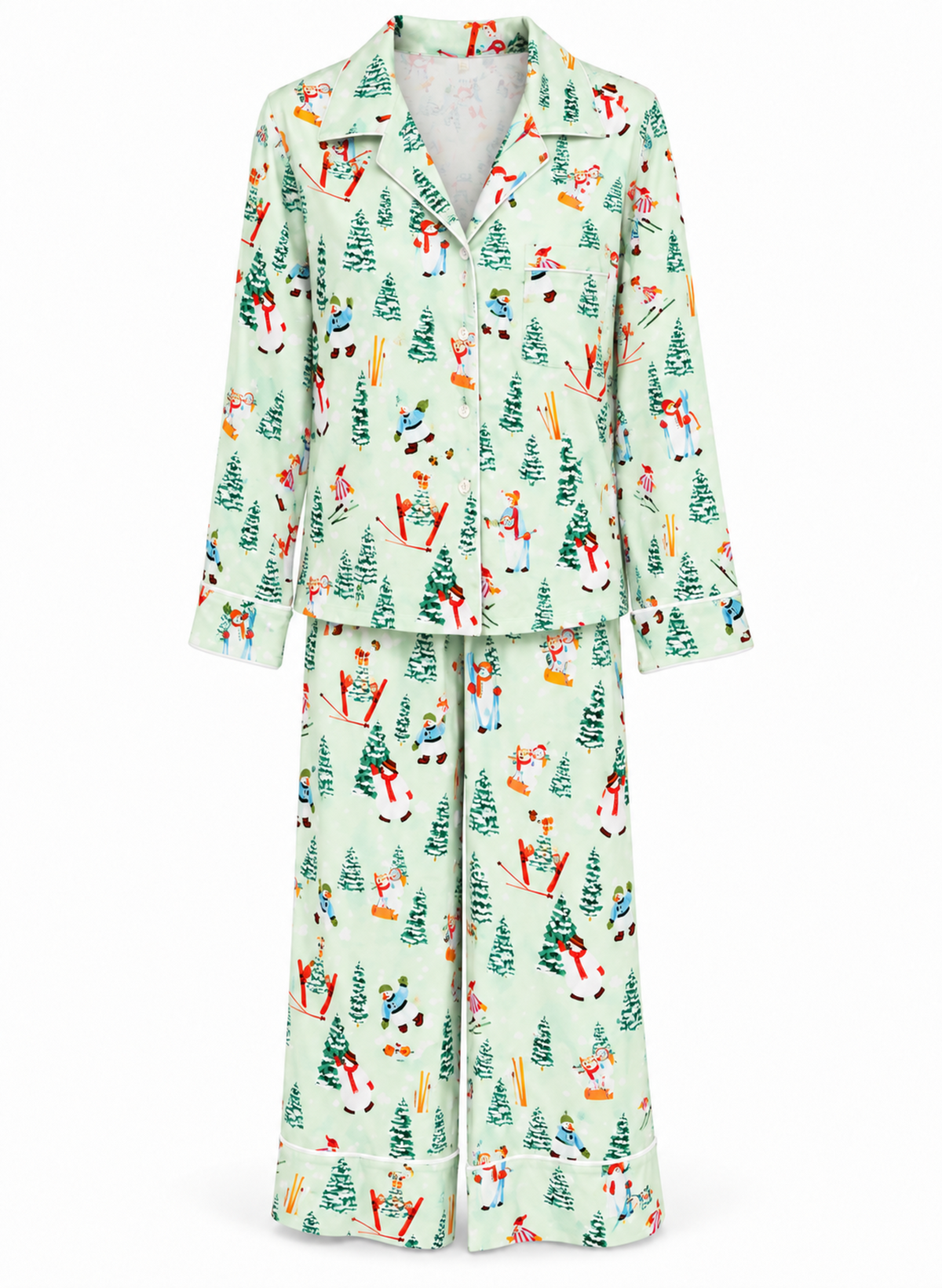 A two-piece pajama set featuring a long-sleeve button-front top and matching wide-leg pants, both in a pale mint green fabric with a colorful winter-themed print of skiers, snowboarders, and Christmas trees.