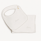 A white baby bib and matching square cloth with scalloped edges and the word 'love' embroidered in script, shown on a plain light background.