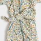 A quilted cotton robe with a woodland animal and plant print, featuring blue-green piping and a matching tie belt.