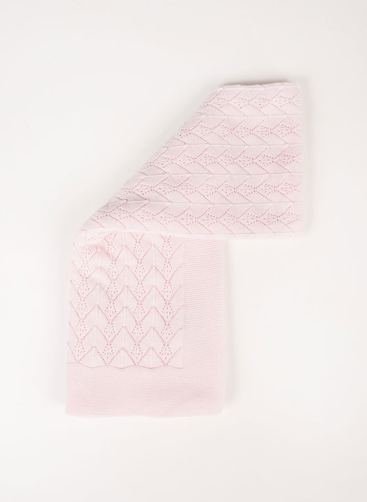 A light pink baby blanket with a textured, eyelet-knit chevron pattern, folded neatly on a clean white background.