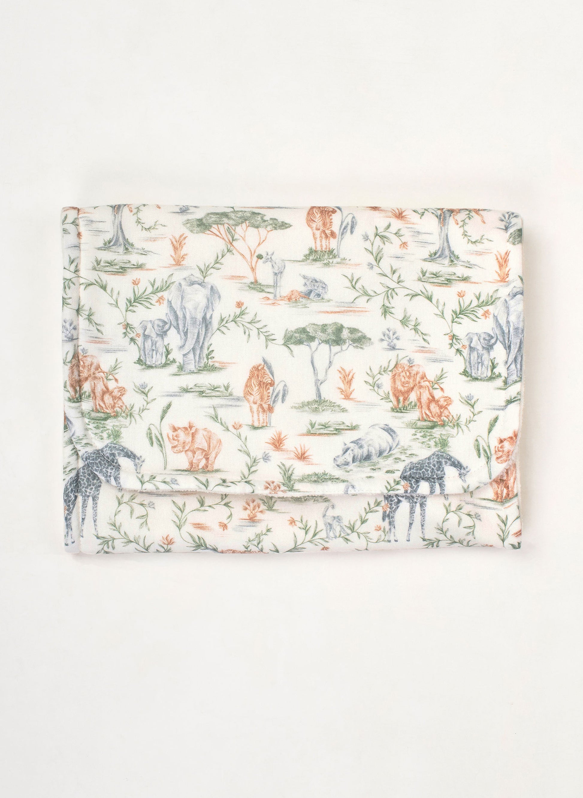 A folded fabric item, likely a blanket or cloth bag, featuring a toile-style safari print with animals and foliage on a cream background.