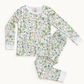 A two-piece long-sleeve pajama set with a white background and a dense, colorful botanical and bird pattern, laid flat on a light cream background.
