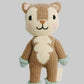 A hand-knitted plush toy of a fox with a brown and cream body, mint green cuffs, and black embroidered facial features, shown against a plain light gray background.
